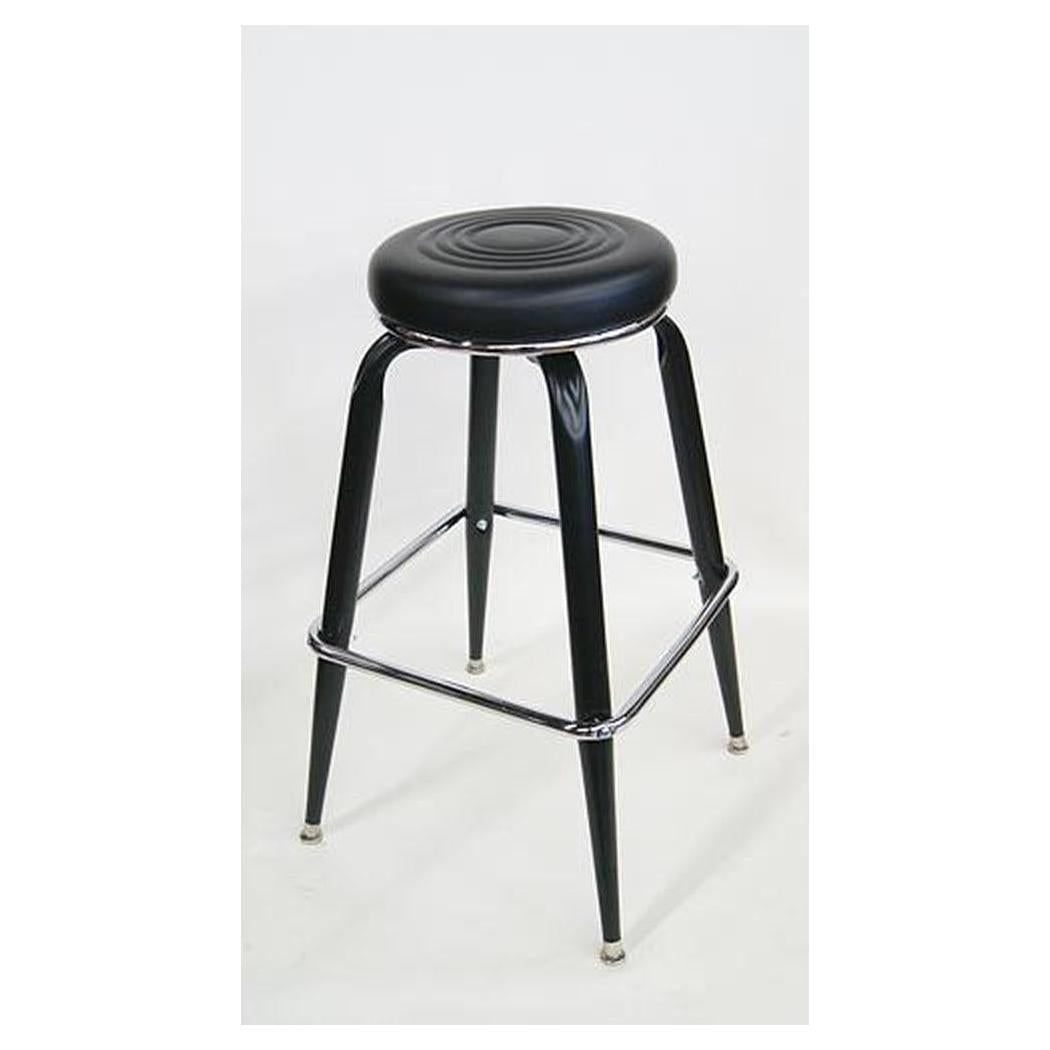 Swivel metal bar stool with black vinyl seat