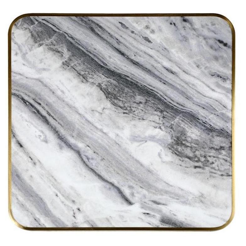 Tabletop in marbled sintered stone with soft gray veining and thick charcoal, 2.9 cm thick with golden edge.