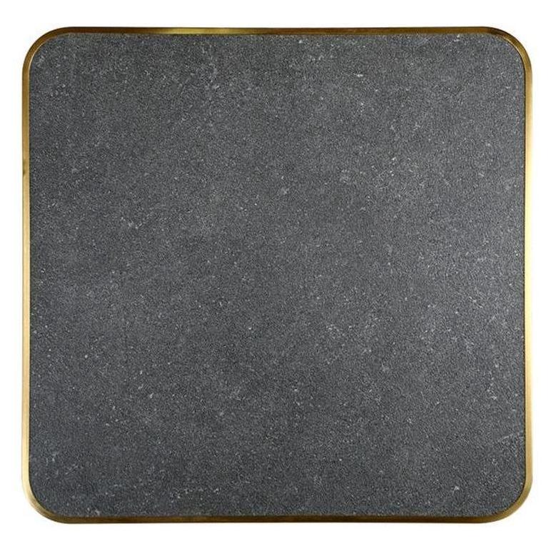 Tabletop in dark speckled sintered stone with a thickness of 2.9 cm and a golden edge.