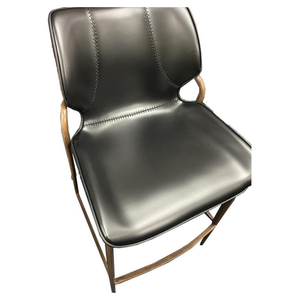 Indoor metal bar stool with wood finish and black vinyl seat